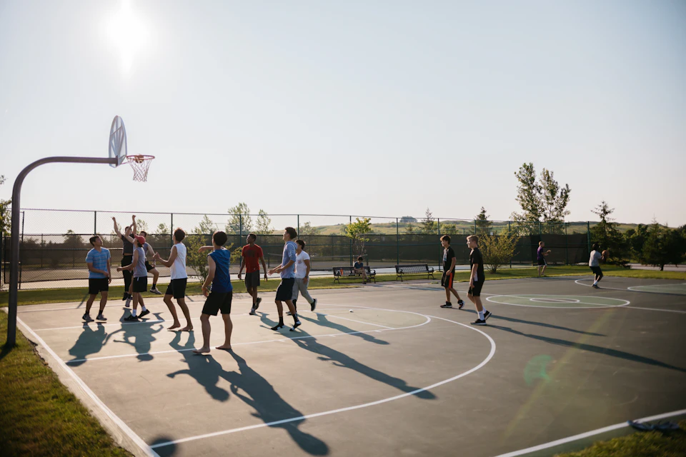 Adults playing basketball in a recreational league