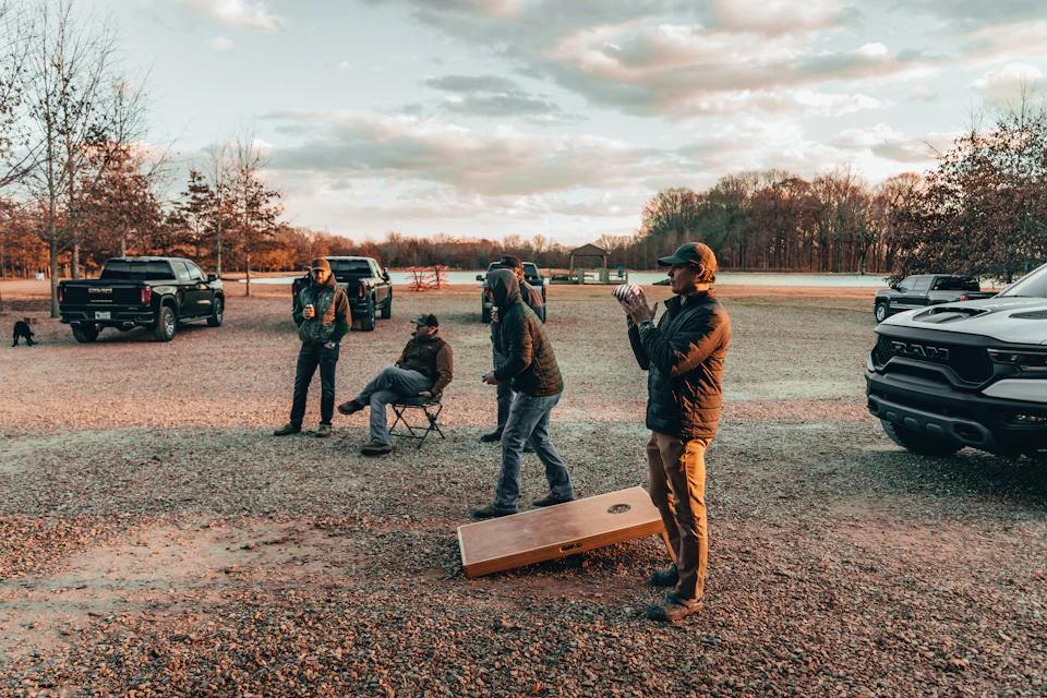Adults playing cornhole in a recreational league