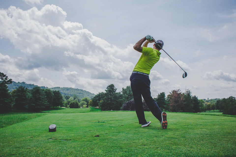Adults playing golf in a recreational league