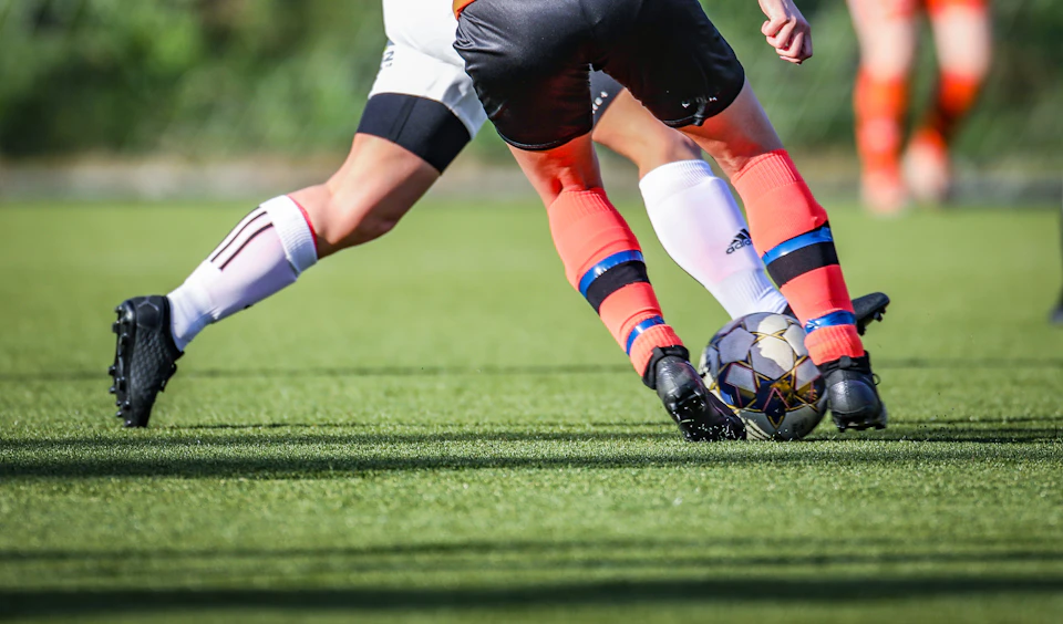 Adults playing soccer in a recreational league