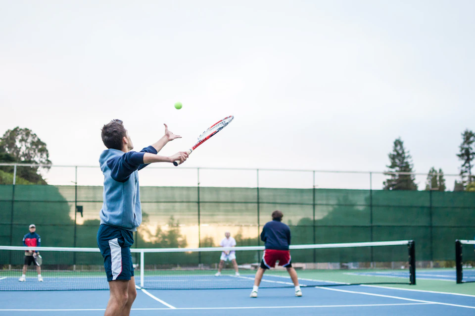 Adults playing tennis in a recreational league