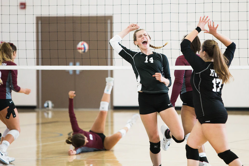 Adults playing volleyball in a recreational league